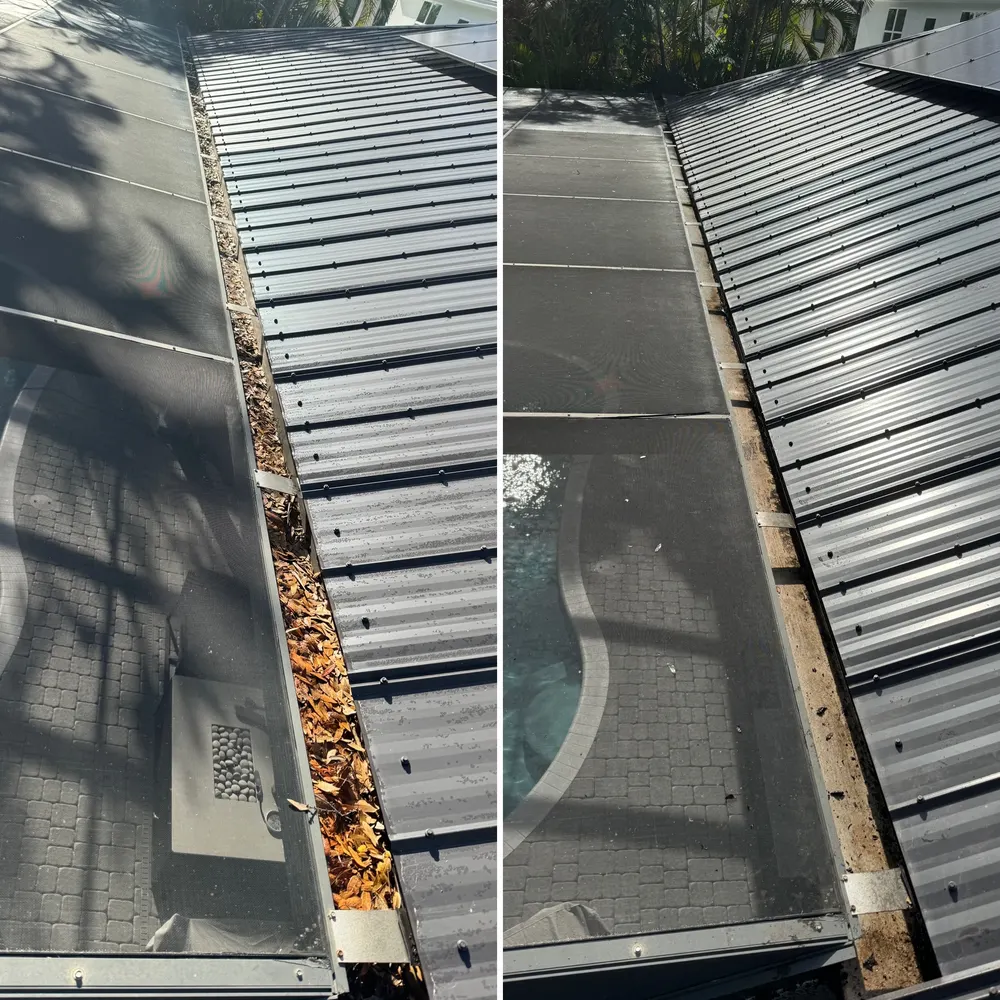 Metal roof gutter being cleaned